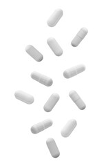 Falling white medicine pills capsule isolated on white background