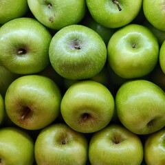 Top view of green apples stacked neatly. Clean composition ideal for packaging, healthy lifestyle,...