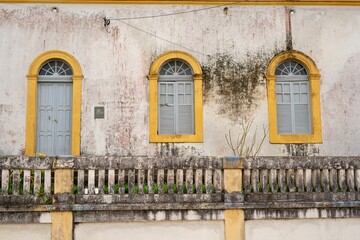 Rustic building facade with arched windows.