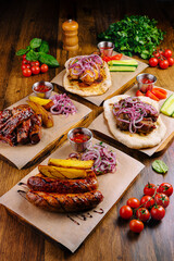 Delicious grilled meats served with fresh vegetables and vibrant sauces