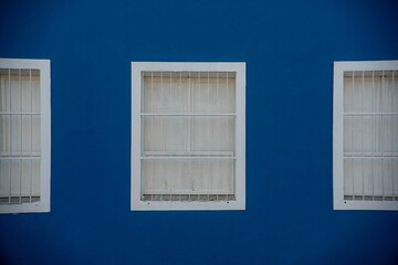 White window frames on blue wall