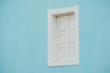 White window frame on blue wall