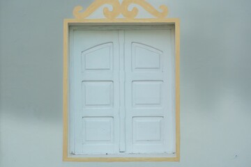Golden window frame against wall