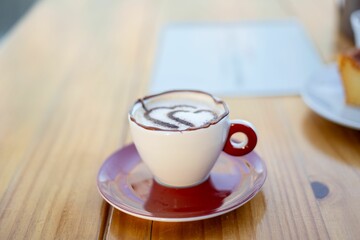 Cappuccino with Latte Art in Red Cup