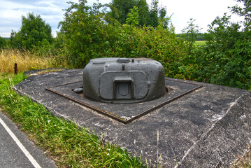 Old sherman tank turret embedded in concrete, repurposed as a fixed fortification in the...