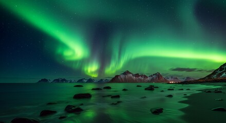 Vibrant green aurora borealis dances across the night sky over a rocky coastline