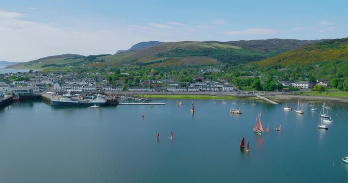 Luggers sail Loch Broom at Lugger Fest in Ullapool Scotland under blue summer skies