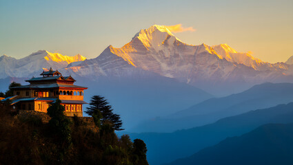 Mountain landscape at dawn with a panoramic view of misty valleys, sun-kissed peaks, and a vibrant sky