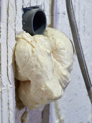 Expanding foam in a PVC pipe during a bathroom renovation