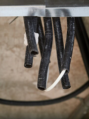 Trachea tubes next to a water pipe in the false ceiling of a home.