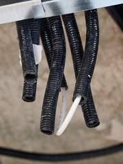 Trachea tubes next to a water pipe in the false ceiling of a home.