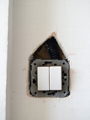 Hole made in plasterboard wall to change the location of a switch