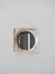 Hole where a light switch used to be in a plasterboard wall. Sliding door installation.