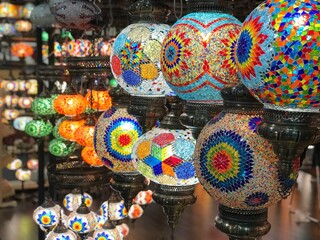 A vibrant display of colorful Turkish mosaic lanterns. These intricately designed lanterns, with...