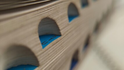 Abstract CloseUp of a Vintage Directory with Blue Tabs and Pages.
