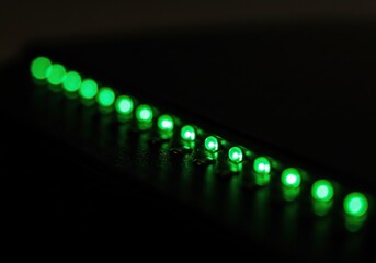 Glowing Green LED Lights in a Row - Abstract Background for Technology, Data, and Futuristic Concepts.