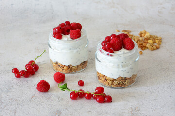 Yogurt Parfaits with Granola and Berries in Glass Jars