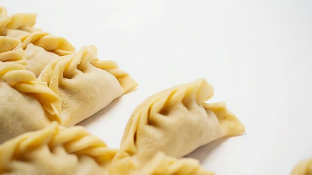 Delicious gyoza dumplings arranged on white background representing asian cuisine