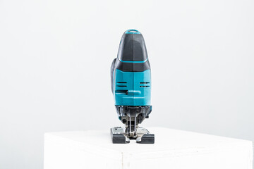 Isolated photo of a cordless jigsaw machine, on white background.