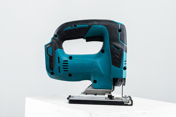 Isolated photo of a cordless jigsaw machine, on white background.