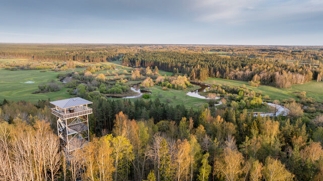 Aerial view to the sunset colored spring landscape of the Mustj&otilde;gi river valley, oxbows and meadows and public watchtower in Tellingum&auml;e, Tsirgum&auml;e k&uuml;la, Valga vald, Valgamaa