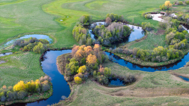 Aerial view to the sunset colored spring landscape of the Mustj&otilde;gi river valley, oxbows and meadows and public watchtower in Tellingum&auml;e, Tsirgum&auml;e k&uuml;la, Valga vald, Valgamaa