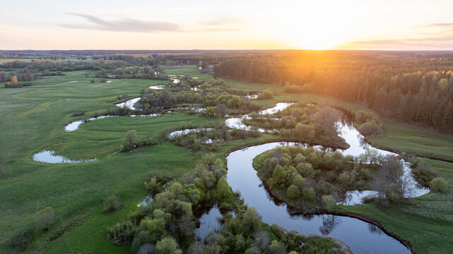 Aerial view to the sunset colored spring landscape of the Mustj&otilde;gi river valley, oxbows and meadows and public watchtower in Tellingum&auml;e, Tsirgum&auml;e k&uuml;la, Valga vald, Valgamaa