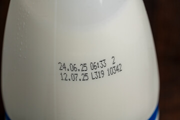 White plastic bottle of milk product with an expiration date. Dairy product , closeup. The concept...