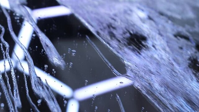 Water droplets and streams flowing on car window