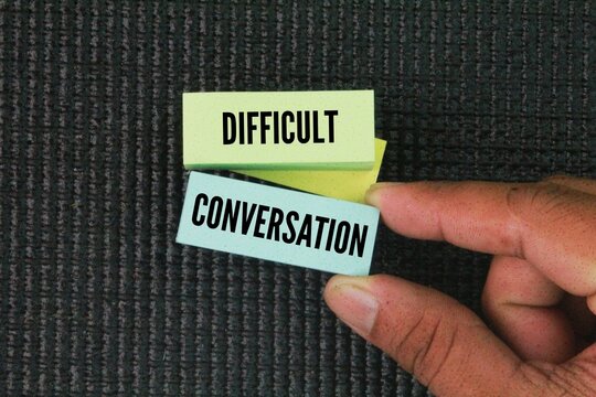 colored paper with the word DIFFICULT CONVERSATION. difficult conversation concepts. a dialogue that addresses sensitive, controversial, or emotionally charged topic