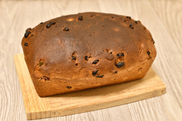 Homemade raisin bread on a wooden stand