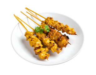 Delicious chicken satay skewers on white plate