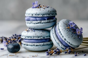 A stack of lavender macarons with blueberry and lavender sprigs on a marble surface close up view