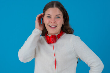 Individuality portrait Young woman wearing red headphones around her neck, smiling happily and...