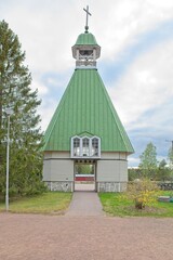 Old wooden Virolahti church belfry in cloudy spring weather, Virolahden kirkonkylä, FInland.