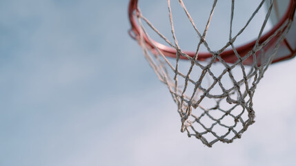 Low angle view of basketball hoop with net against blue sky