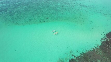 2 Kayakers paddling along in tropical waters next to the vibrant reef.