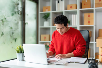 Remote Work and E-commerce. Young man managing online business from home office.