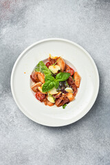 Bowl of fresh caesar salad, plate, on a stone table. Top view copy space. fresh organic salad. Diet food. Healthy meal.