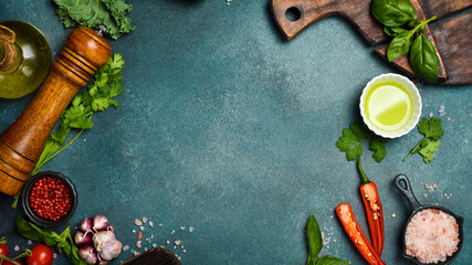 Stone black cooking background. Kitchen board with vegetables and spices. On a black stone...