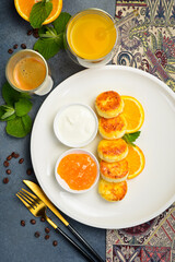 Breakfast. Cheese pancakes with orange jam and sour cream. Healthy meal.