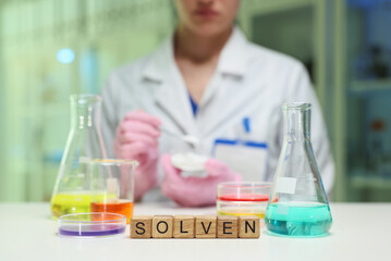 A scientist works with colorful solutions, showcasing fascinating chemistry in action within a lab...