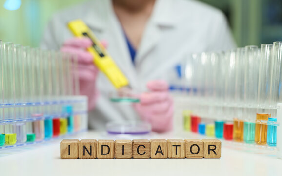 A dedicated scientist is conducting a detailed experiment using colorful chemical indicators within a lab setting