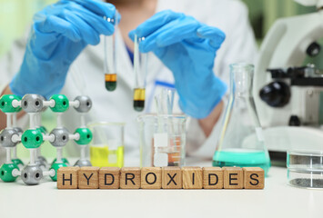 A laboratory technician conducts a detailed study of hydroxides utilizing test tubes and various...