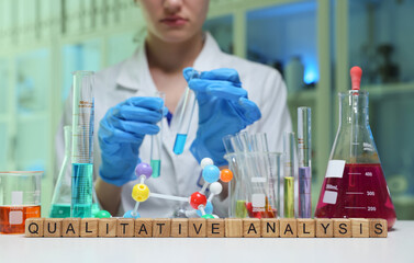 A skilled scientist conducts qualitative analysis in a lab filled with colorful chemicals and...