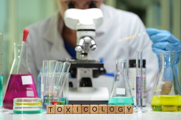 A detailed closeup view showcasing intricate work in a toxicology lab, featuring colorful solutions...