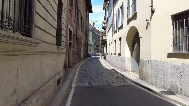 A camera moves ahead on the narrow street in the historical district of the city of Milan