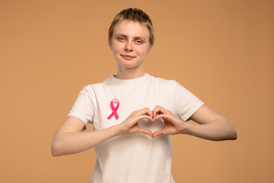 Woman Supporting Breast Cancer Awareness with Pink Ribbon