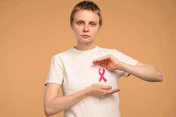 Woman Supporting Breast Cancer Awareness with Pink Ribbon