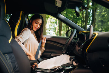 Safety first, with belt. Woman is with her car in the forest